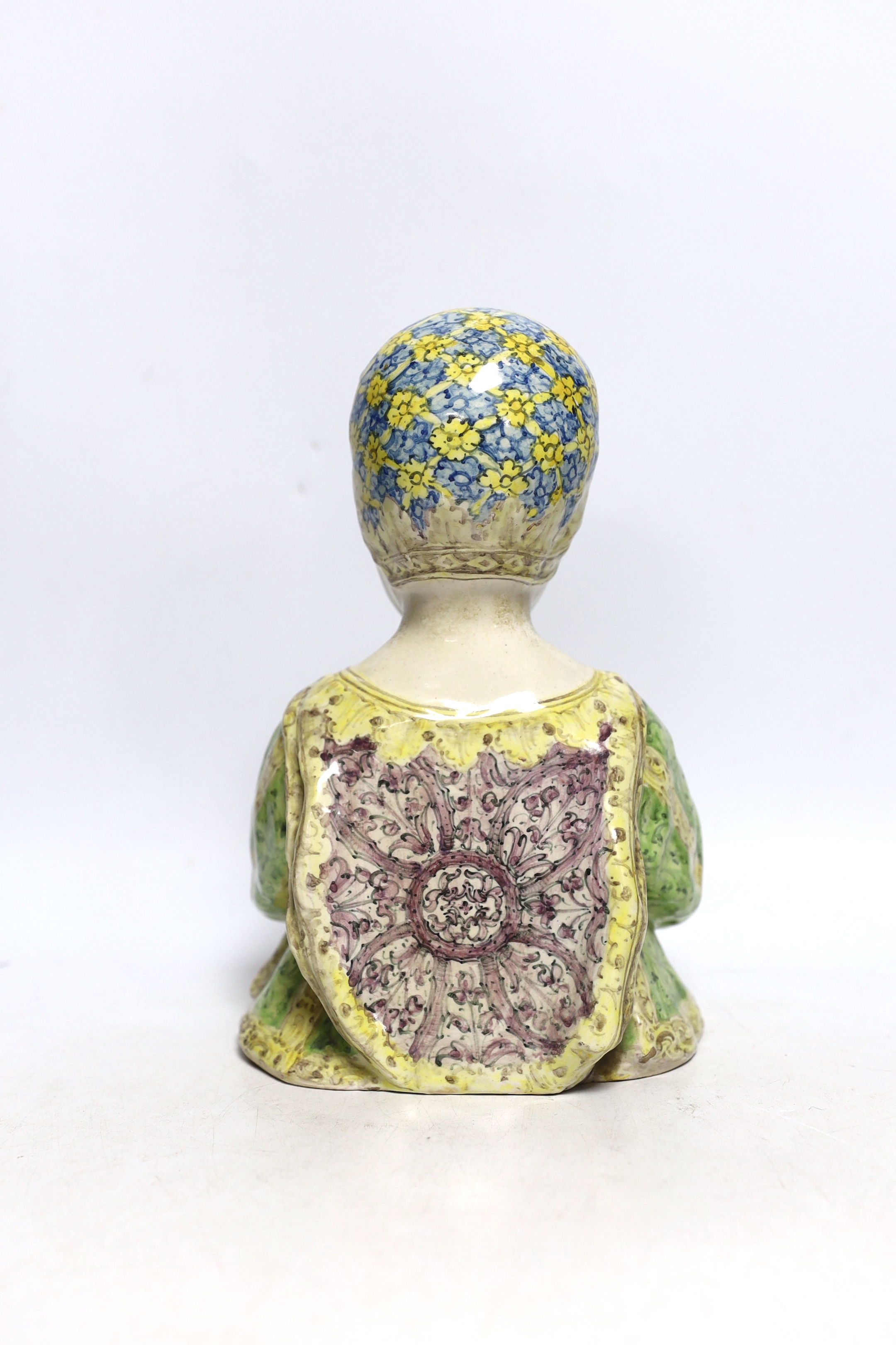 Angelo Minghetti, a late 19th century Italian maiolica Half length model of a Renaissance child holding an apple, 24cm